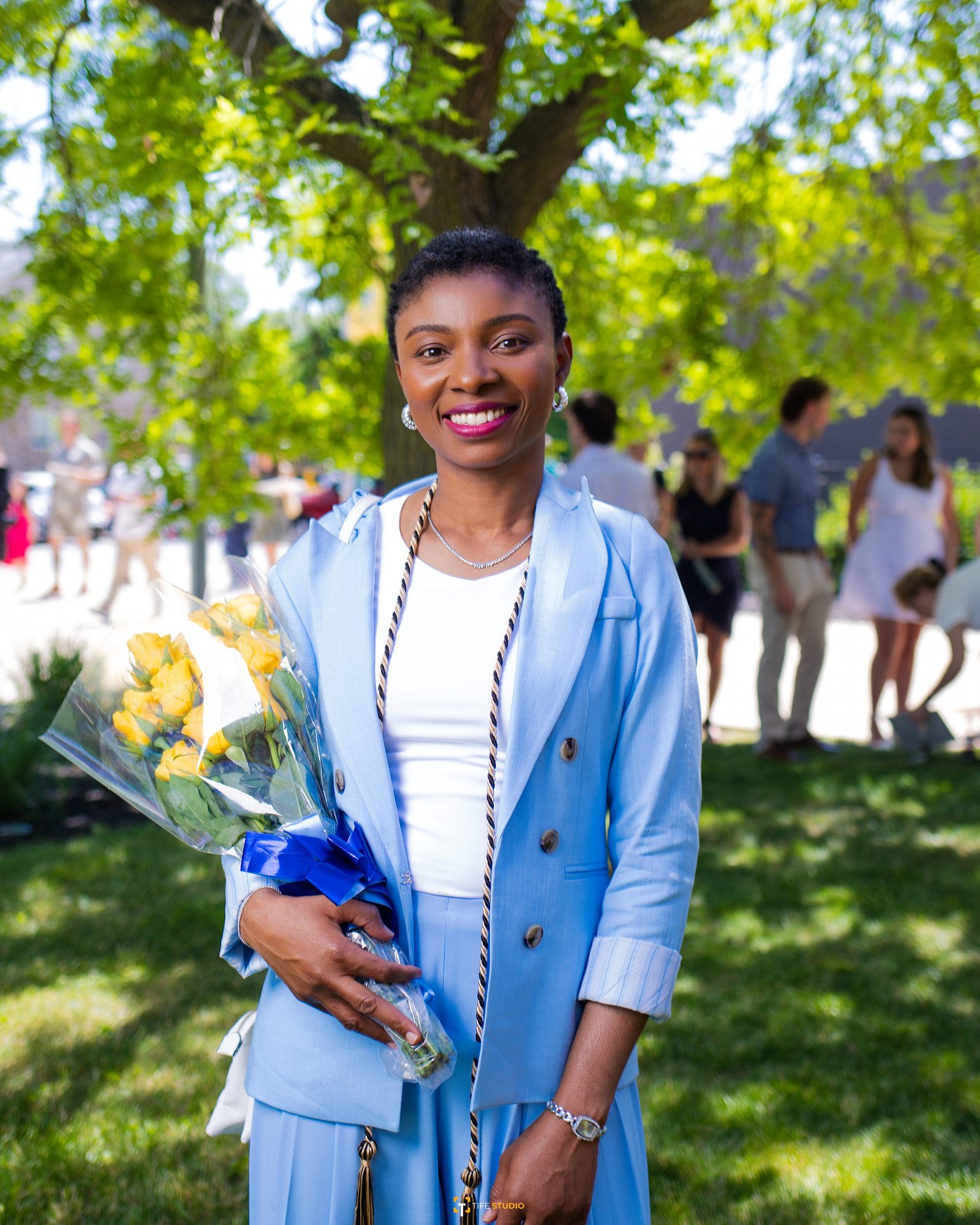 Graduate outdoor portrait with flowers
